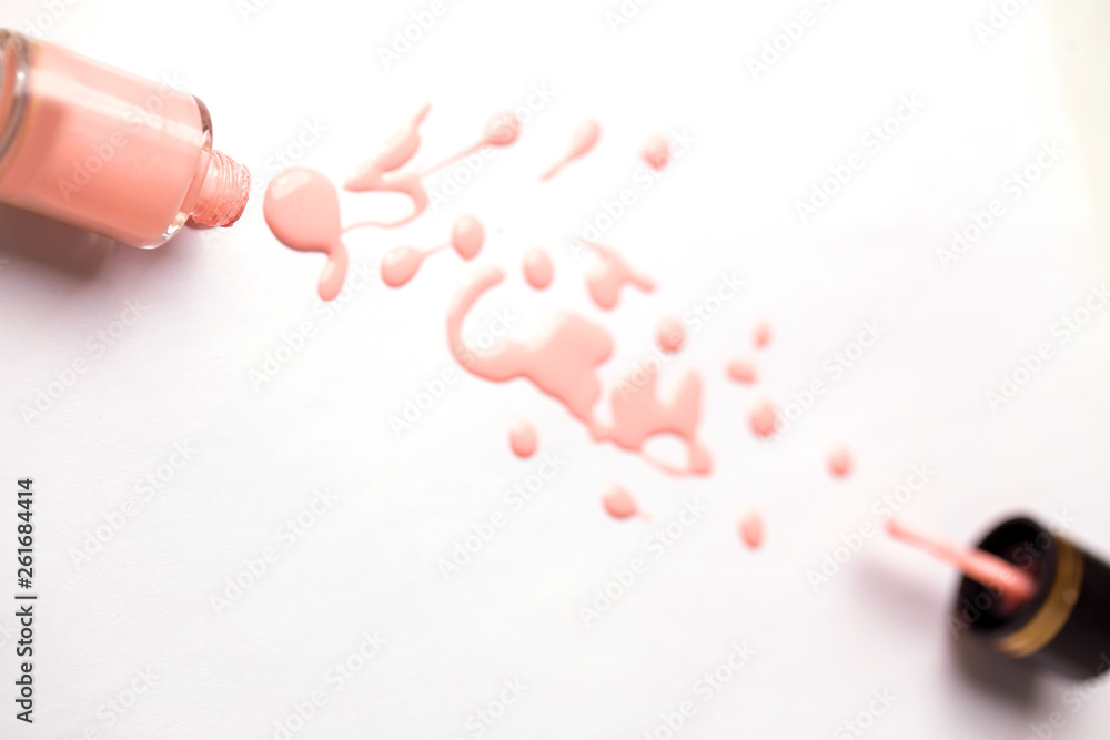 Nail polish bottle and drop on white background Nail polish bottle and drop on white background
