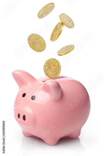 Fényképezés Pink piggy bank with falling coins, isolated on white background