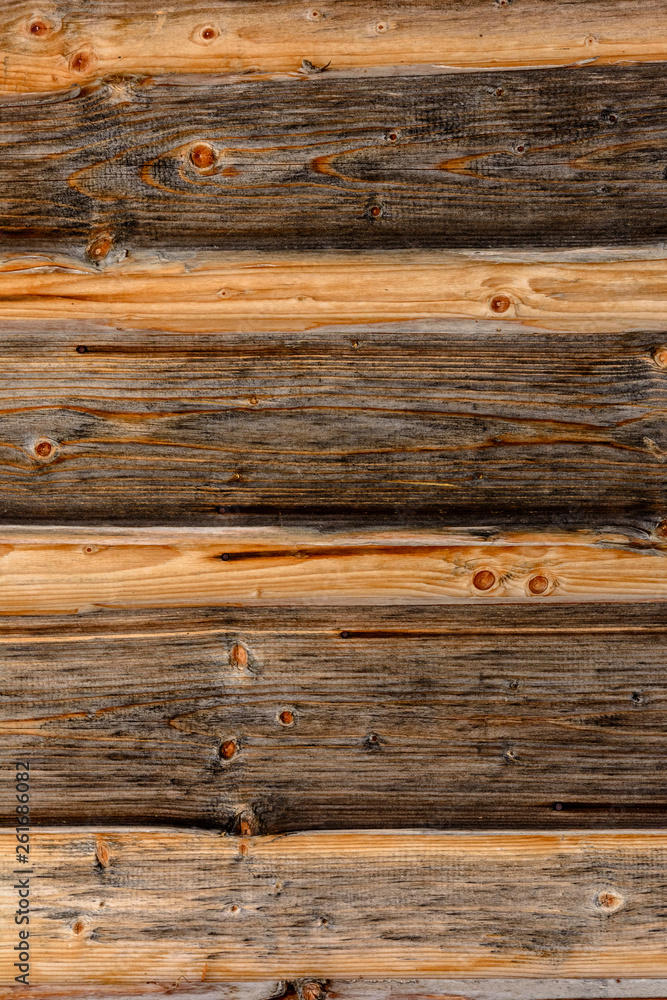 The structure of the wooden log wall, texture of wooden beams The structure of the wooden log wall, texture of wooden beams