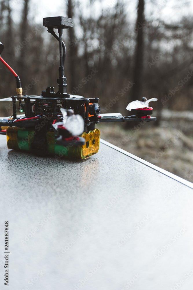 A small self made FPV drone lies on the table before the flight. A small self made FPV drone lies on the table before the flight.