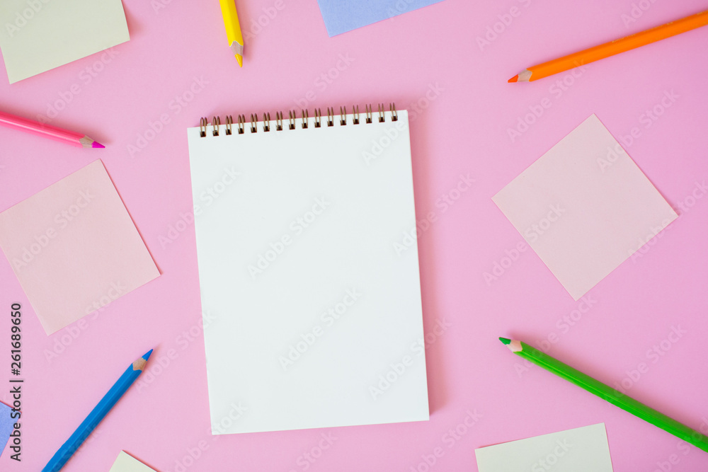 Color note papers and notebook with pencils on pink background. Color note papers and notebook with pencils on pink background.
