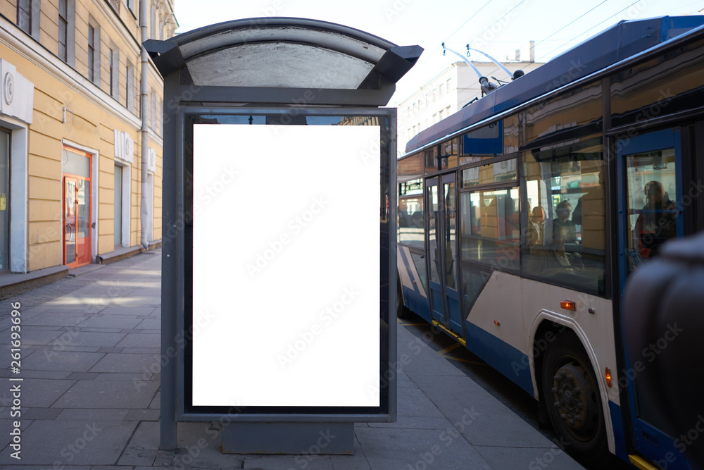 vertical advertising billboard ad in the bus stop. white box for placement in advertising banners. It is located in the city near the road. - obrazy, fototapety, plakaty 