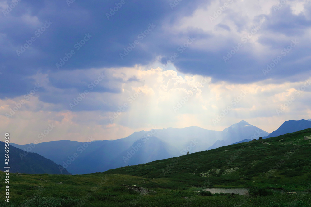 Marvellous sky landscape in the mountains. Sun rays make their way through the clouds