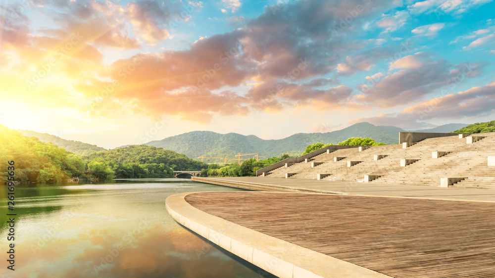 Fototapeta premium Wooden floor platform and lake with green mountains background in Hangzhou