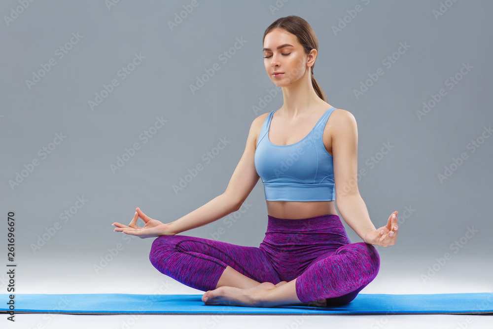 Young girl doing yoga, studio