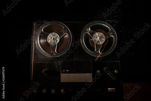 Special agent intelligence officer listens to conversations and records on a reel to reel tape recorder 3