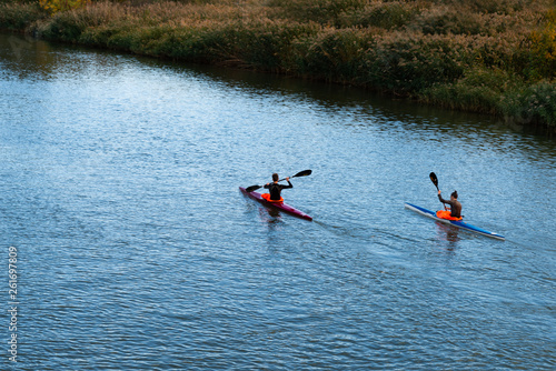 kayakers are racing on the river in a canoe marathon,  outdoor movement and canoeing promotes health and protects from diseases