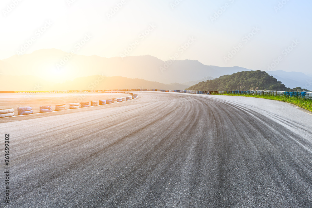 Empty asphalt race track ground and mountains landscape