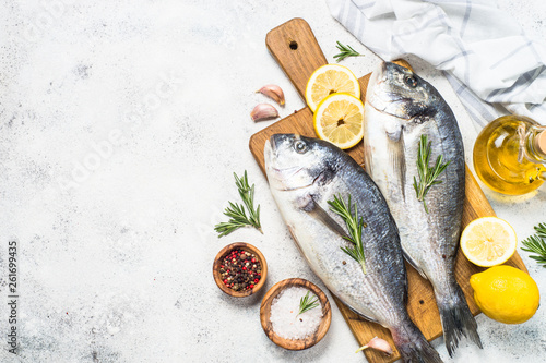 Photography Raw dorado fish on cutting board on the table.