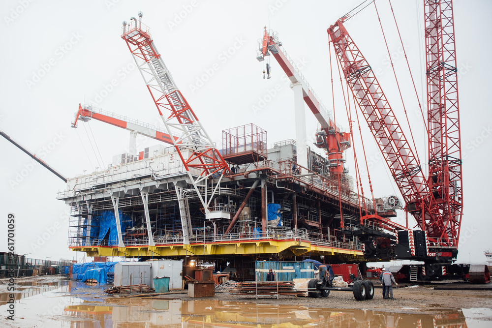 Oil platform under construction and large cranes