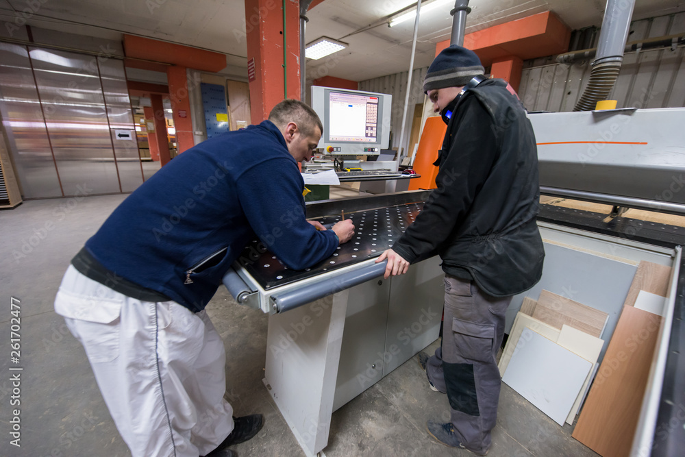 carpenters calculating and programming a cnc wood working machine carpenters calculating and programming a cnc wood working machine