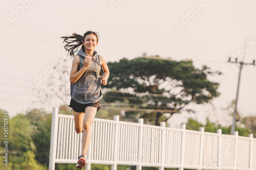 young woman runner running on running road in city park © only_kim