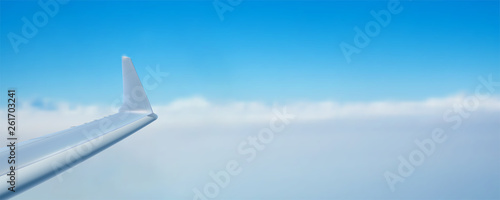 View of the sky and wing of the aircraft from the window. Time to travel. Air transport in the blue clear sky. Realistic vector 3d illustration for touristic and travel agency