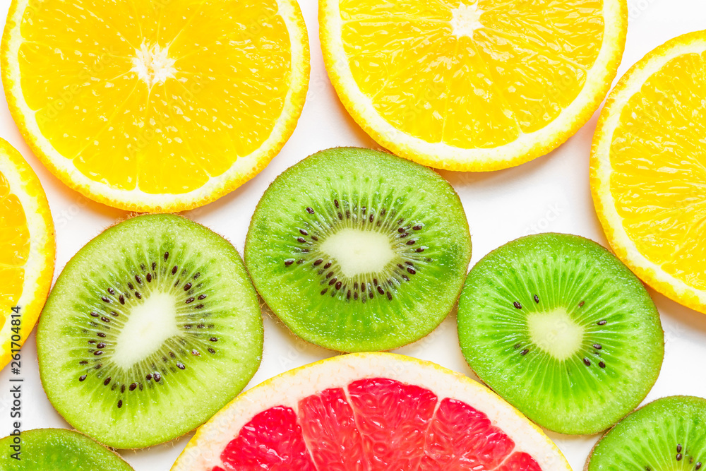 citrus slices - kiwi, oranges and grapefruits on white background. Fruits backdrop citrus slices - kiwi, oranges and grapefruits on white background. Fruits backdrop