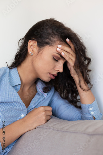 Young woman suffering strong headache