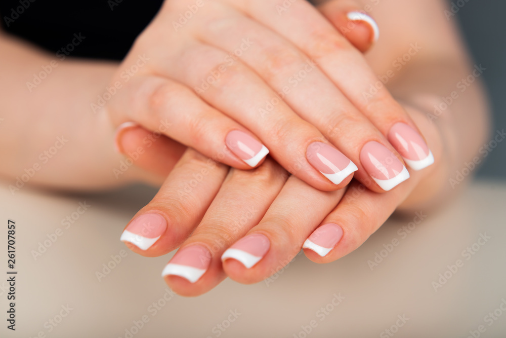 Beautiful woman's hands with beautiful nails after manicure salon with french manicure Beautiful woman's hands with beautiful nails after manicure salon with french manicure