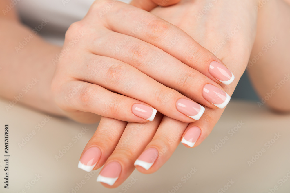 Beautiful woman's hands with beautiful nails after manicure salon with french manicure Beautiful woman's hands with beautiful nails after manicure salon with french manicure