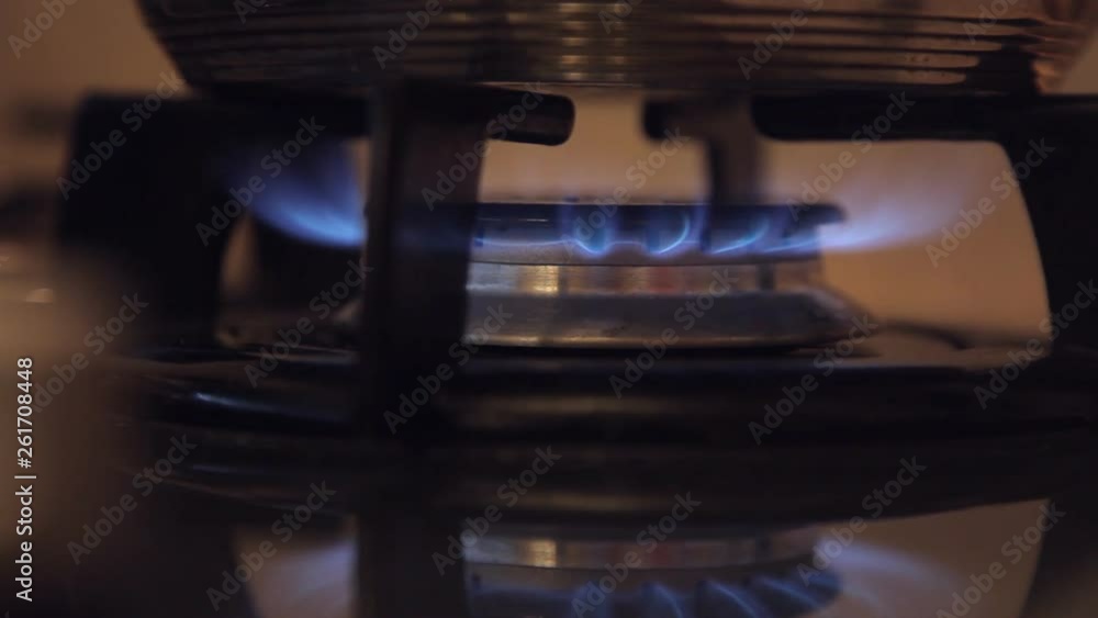 in a dirty budget kitchen with a dim light on the gas stove in a dirty budget kitchen with a dim light on the gas stove