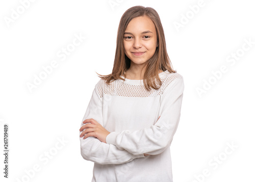 Beautiful Teen Girl Student with confident expression, keeps arms folded. Portrait of Smiling Teenager isolated on white background. Happy child looking at camera.