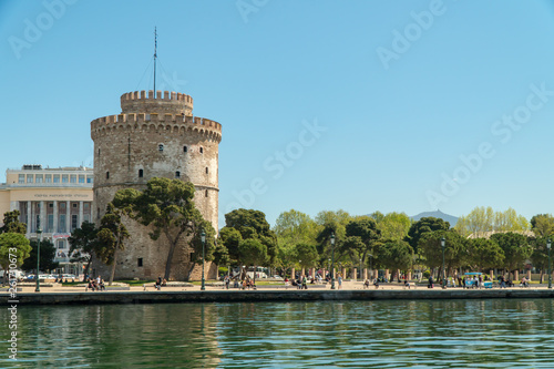 Thessaloniki / Greece 11 April 2019 the blue sea and the white tower of thessaloniki city's symbol and landmark ,beautiful sunny day after long time of rain and clouds great opportunity for a walk.
