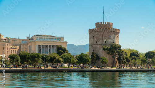 Thessaloniki / Greece 11 April 2019 the blue sea and the white tower of thessaloniki city's symbol and landmark ,beautiful sunny day after long time of rain and clouds great opportunity for a walk.