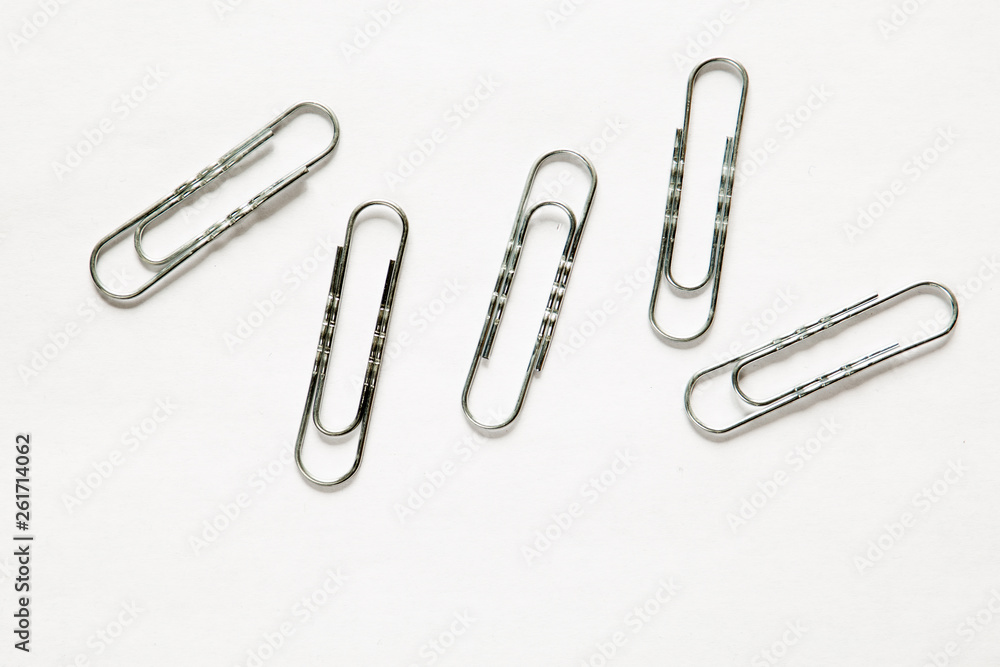 silver paper clips on white background silver paper clips on white background