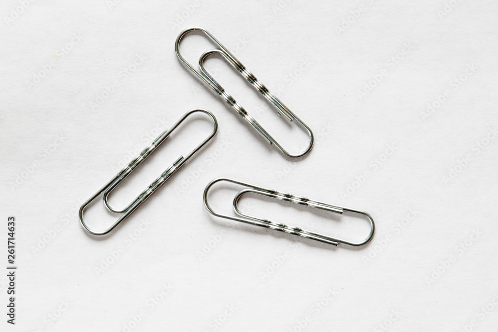 silver paper clips on white background silver paper clips on white background