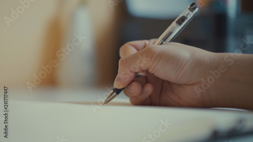 Close up of hand writing letter. Male hand signing important documents.