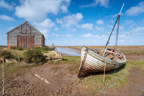 An old fishing boat under a blue sky at Thornham