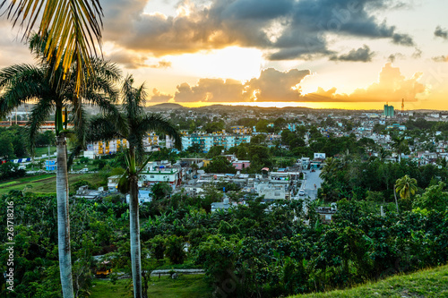 Photography Cuban city sunset panorama with palms it the foreground, Santa Clara, Cuba