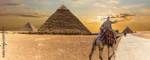 The Great Pyramids of Giza and a bedouin, desert panorama photo