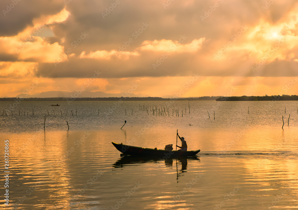 fishing boat at sunset on the lake in Sri Lanka