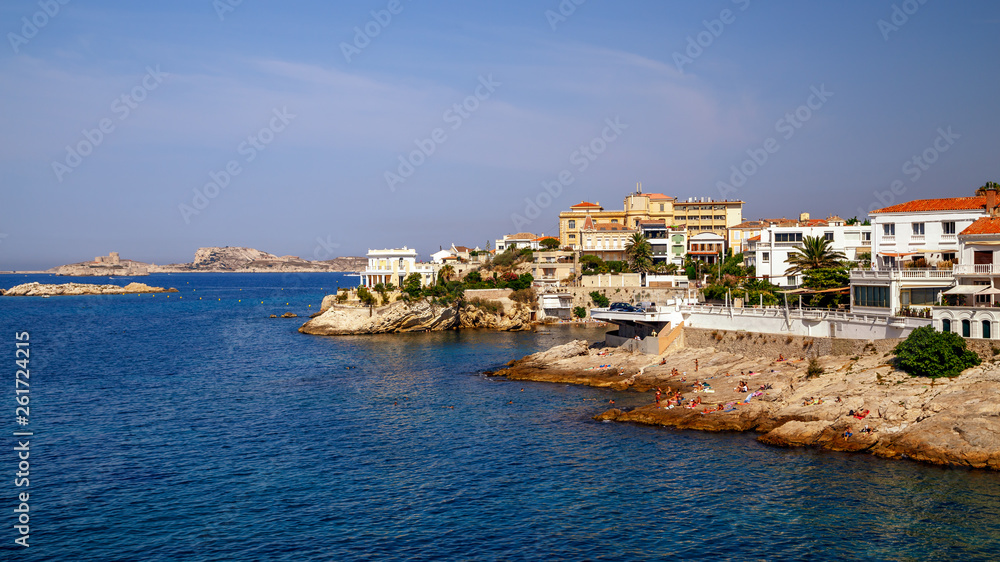 Coastline in Marseille, rocky coast, relaxing people in a sunny summer day, mediterranean houses, summer holidays, southern France.