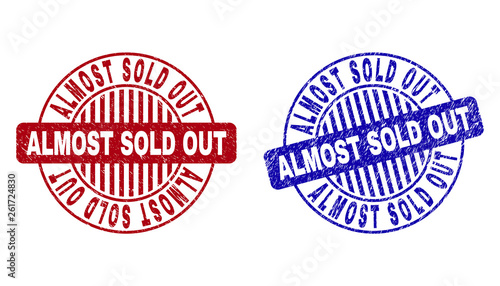Grunge ALMOST SOLD OUT round stamp seals isolated on a white background. Round seals with grunge texture in red and blue colors.