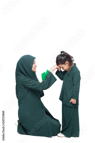 Daughter asking for forgiveness from mother during Raya, a muslims festive celebration