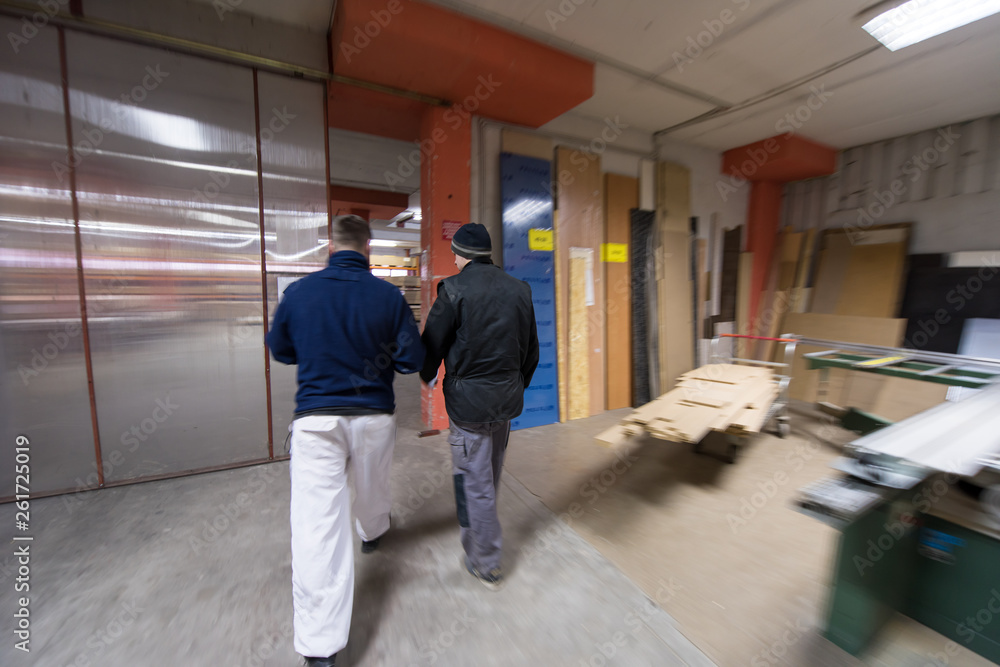 two young carpenters working in big modern carpentry