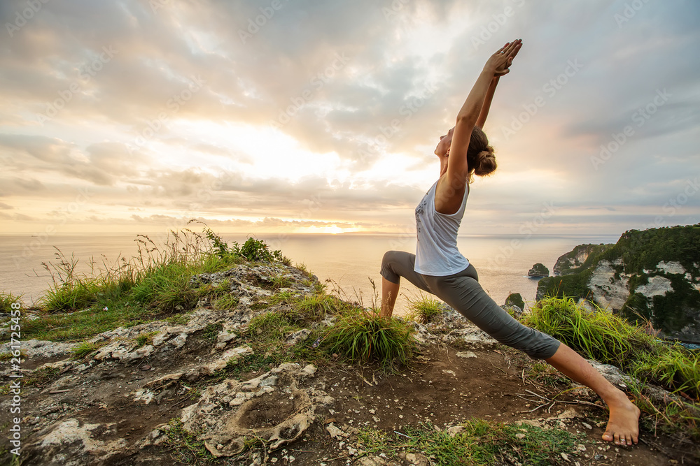 Caucasian woman practicing yoga at seashore Caucasian woman practicing yoga at seashore
