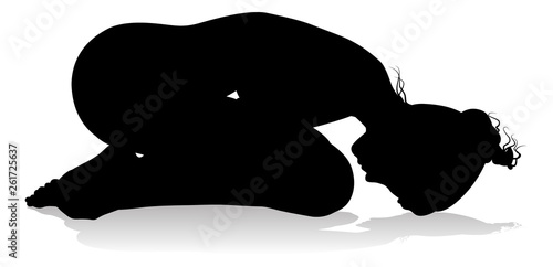 A silhouette of a woman in a yoga or pilates pose 