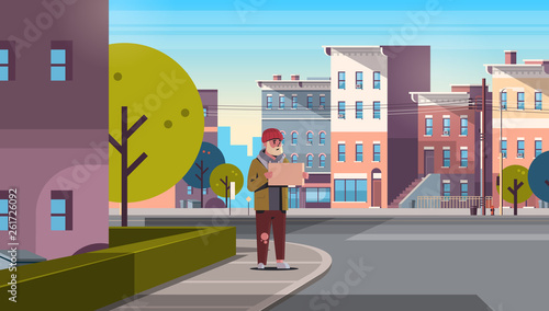poor bearded man begging for help beggar guy holding sign board homeless jobless concept modern city street cityscape background horizontal full length