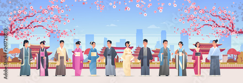 asian people grroup in traditional clothes men women wearing ancient costumes standing together chinese or japanese characters over pagoda buildings landscape background full length horizontal