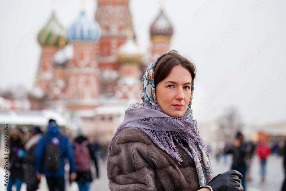 Young woman in fur mink coat on a red square in the center of Moscow