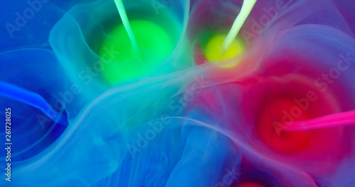Colorful Rainbow Paint Threads and Drops Mixing in Water. Ink swirling. Underwater 4K Macro Shot.