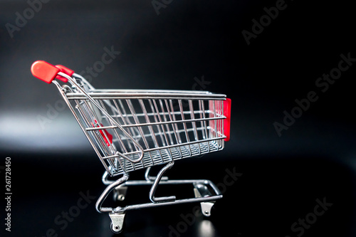 Trolley shopping cart on black background.