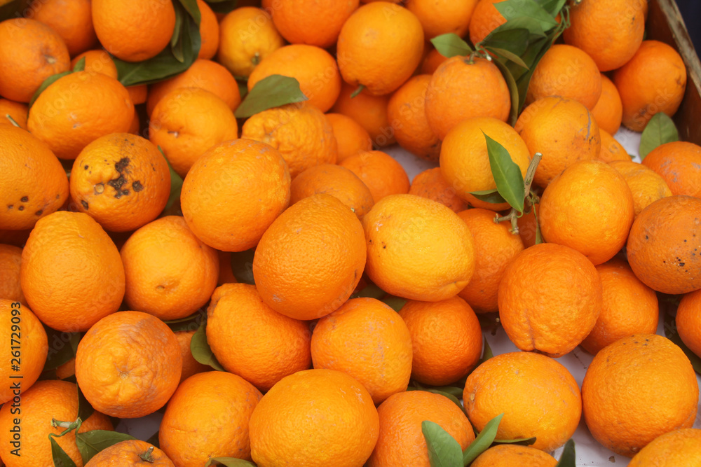 Big pile of ripe oranges with leaves Big pile of ripe oranges with leaves