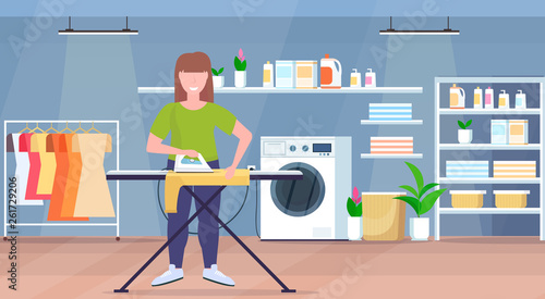 housewife ironing clothes young woman holding iron smiling girl doing housework concept modern laundry room interior female cartoon character full length flat horizontal