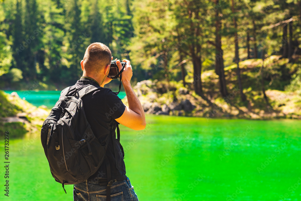 Hiker with camera at green lake in styria Austria Hiker with camera at green lake in styria Austria