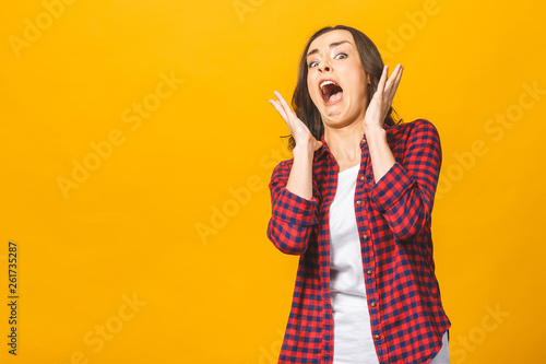 I'm afraid. Fright. Portrait of the scared woman. Business woman standing isolated against yellow studio background. Human emotions, facial expression concept. Front view