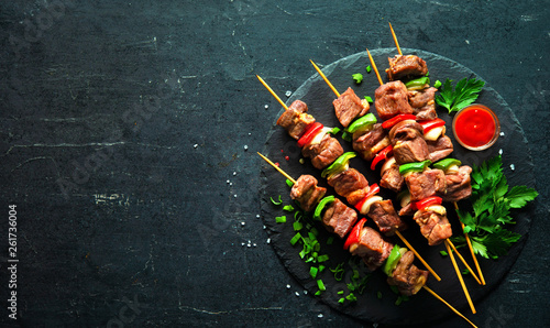 Grilled meat and vegetables on skewers photo
