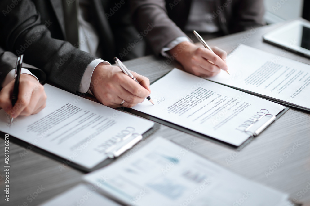 close up. business partners sign a new contract close up. business partners sign a new contract