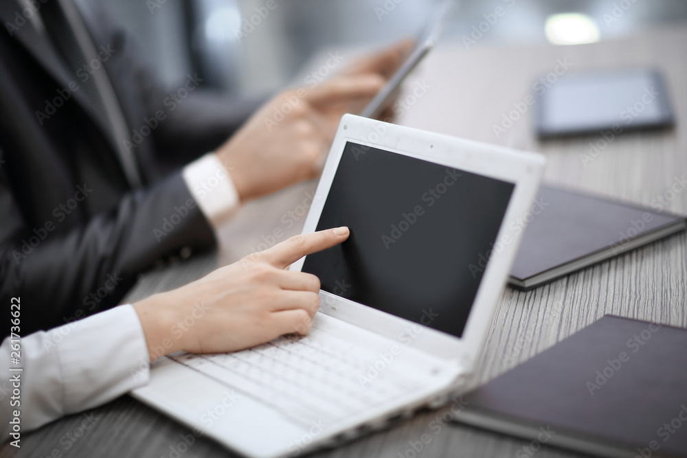 close up.business woman pointing at laptop screen close up.business woman pointing at laptop screen